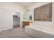 Bathroom with soaking tub, double sink vanity, and a walk-in closet at 6915 S Sapphire Way, Chandler, AZ 85249