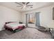 Spacious bedroom with a ceiling fan, carpet floors, a window and neutral walls at 6915 S Sapphire Way, Chandler, AZ 85249