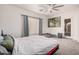 Spacious bedroom with a ceiling fan, carpet floors, a window and neutral walls at 6915 S Sapphire Way, Chandler, AZ 85249