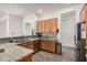 Functional kitchen with granite countertops, stainless steel appliances, and wooden cabinets at 6915 S Sapphire Way, Chandler, AZ 85249