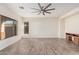 Bright, open living room with tile floors, a ceiling fan, and plentiful natural light at 6915 S Sapphire Way, Chandler, AZ 85249