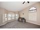 Spacious bedroom with neutral carpet, light walls, a ceiling fan and multiple windows at 819 W Harbor Dr, Gilbert, AZ 85233