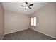 Cozy bedroom with neutral carpet, light walls, and a ceiling fan at 819 W Harbor Dr, Gilbert, AZ 85233