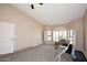 Spacious bedroom with neutral carpet, light walls, a ceiling fan and multiple windows at 819 W Harbor Dr, Gilbert, AZ 85233