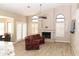 Bright living room with fireplace, wood-look tile flooring, and lots of natural light at 819 W Harbor Dr, Gilbert, AZ 85233