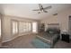 Spacious main bedroom with shuttered windows, ceiling fan, and tufted bed with an attached bench at 819 W Harbor Dr, Gilbert, AZ 85233