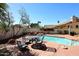 Beautiful outdoor space with a pool, dining area, and well-maintained patio, ideal for relaxation at 819 W Harbor Dr, Gilbert, AZ 85233