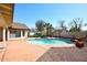 Inviting backyard pool with a tranquil rock feature and ample patio space for outdoor enjoyment at 819 W Harbor Dr, Gilbert, AZ 85233