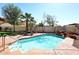 Backyard pool with rock features and a charming outdoor dining area for entertaining guests at 819 W Harbor Dr, Gilbert, AZ 85233