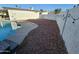 Backyard features a clean pool, stone ground cover, and a string of lights on the fence at 8227 N 47Th Dr, Glendale, AZ 85302