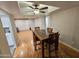 Open dining room featuring a ceiling fan and wooden table with seating for four at 8227 N 47Th Dr, Glendale, AZ 85302