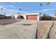 Charming single-story home with a well-manicured front yard and a red garage door at 8227 N 47Th Dr, Glendale, AZ 85302