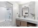 Modern bathroom featuring marble accent wall, sleek fixtures, and a glass-enclosed shower for a spa-like experience at 9114 N 55Th St, Paradise Valley, AZ 85253