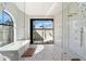 Modern bathroom featuring a soaking tub, a glass shower, and access to the backyard at 9114 N 55Th St, Paradise Valley, AZ 85253