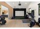 Well-equipped home gym with a workout machine, weights, and a projector screen at 9114 N 55Th St, Paradise Valley, AZ 85253