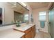 Bathroom featuring light colored cabinets, tile flooring, and a large mirror at 9634 W Glen Oaks N Cir, Sun City, AZ 85351