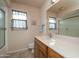 Bright bathroom with a shower-tub combo, and a vanity with a large mirror and ample counter space at 9634 W Glen Oaks N Cir, Sun City, AZ 85351