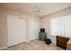 Bedroom features tile floors, a ceiling fan, and a closet with sliding doors at 9634 W Glen Oaks N Cir, Sun City, AZ 85351