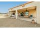 Charming covered patio with comfortable seating and a ceiling fan, perfect for outdoor entertaining and relaxation at 9634 W Glen Oaks N Cir, Sun City, AZ 85351