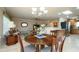 Bright open floorplan features dining room with dark wood table, wood chairs, and tile flooring at 9634 W Glen Oaks N Cir, Sun City, AZ 85351