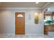 Inviting entryway with decorative door, neutral paint, and view to dining area and kitchen at 9634 W Glen Oaks N Cir, Sun City, AZ 85351