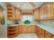 Bright kitchen featuring shaker cabinets, light countertops, neutral tile backsplash, and plenty of storage at 9634 W Glen Oaks N Cir, Sun City, AZ 85351