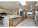 Well-lit kitchen featuring a skylight, stainless steel appliances, and tile flooring at 9634 W Glen Oaks N Cir, Sun City, AZ 85351