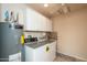 Laundry room featuring washer, dryer, water heater, and plenty of storage space at 9634 W Glen Oaks N Cir, Sun City, AZ 85351