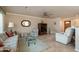 Spacious living room featuring tile flooring, neutral-colored walls, and comfortable seating at 9634 W Glen Oaks N Cir, Sun City, AZ 85351