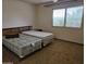 Bedroom features two twin beds, a neutral color palette, and ample natural light from the large window at 9847 W Silver Bell Dr, Sun City, AZ 85351