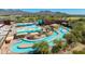 Aerial view of community pool featuring a lazy river, multiple pools, lounge areas, and shaded seating at 9850 E Mcdowell Mountain Ranch Rd # 1006, Scottsdale, AZ 85260