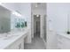 The bright bathroom features double sinks, a vanity area, a walk-in closet, and a glass shower at 9850 E Mcdowell Mountain Ranch Rd # 1006, Scottsdale, AZ 85260