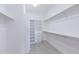 This spacious walk-in closet includes built-in shelves and multiple rods for ample storage at 9850 E Mcdowell Mountain Ranch Rd # 1006, Scottsdale, AZ 85260