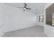 A minimalist designed living room with tile floors, a ceiling fan and a window at 9850 E Mcdowell Mountain Ranch Rd # 1006, Scottsdale, AZ 85260