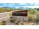 View of Market Street sign with stone base, surrounded by desert landscape and mountain views at 9850 E Mcdowell Mountain Ranch Rd # 1006, Scottsdale, AZ 85260