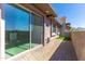 View of the covered patio with brick floor and sliding glass door creating an inviting outdoor living space at 9850 E Mcdowell Mountain Ranch Rd # 1006, Scottsdale, AZ 85260