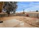 Large backyard featuring a mature tree, brick landscaping borders, and privacy fencing at 10135 W Orange Dr, Glendale, AZ 85307