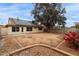 Exterior backyard view showcasing solar panels, covered patio and brick accented landscaping at 10135 W Orange Dr, Glendale, AZ 85307