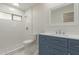 Renovated bathroom featuring vanity with sink and a white tiled walk-in shower at 10135 W Orange Dr, Glendale, AZ 85307