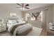 Comfortable bedroom boasts a ceiling fan, a large window, and neutral tones, creating a serene space at 10135 W Orange Dr, Glendale, AZ 85307