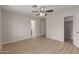 Neutral bedroom featuring wood-look floors, ceiling fan and open closet at 10135 W Orange Dr, Glendale, AZ 85307