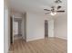 Neutral bedroom featuring wood-look floors, ceiling fan and open closet at 10135 W Orange Dr, Glendale, AZ 85307