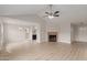 Open-concept living room with new floors, fireplace, high ceilings, and lots of natural light at 10135 W Orange Dr, Glendale, AZ 85307