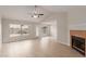 Bright living room with vaulted ceilings, new floors, a fireplace, and backyard access at 10135 W Orange Dr, Glendale, AZ 85307