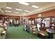 Inside the pro shop filled with golf equipment, apparel, and accessories, with dark wood shelving and green carpet at 10343 E Cherrywood Ct, Sun Lakes, AZ 85248