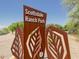 Scottsdale Ranch Park sign with metal leaf design, surrounded by desert landscape at 10538 E Gold Dust Cir, Scottsdale, AZ 85258