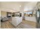 Bright kitchen featuring a center island, stainless steel appliances, and an adjacent fireplace at 10538 E Gold Dust Cir, Scottsdale, AZ 85258