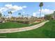 Beautiful landscaped grounds with a sidewalk leading to the community tennis courts at 10538 E Gold Dust Cir, Scottsdale, AZ 85258