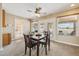 Cozy dining area with a ceiling fan, carpeted floors, and access to the outdoor patio through glass doors at 10848 W Crosby Dr, Sun City, AZ 85351