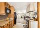 Bright kitchen featuring wood cabinets, granite countertops, and stainless steel appliances at 10848 W Crosby Dr, Sun City, AZ 85351